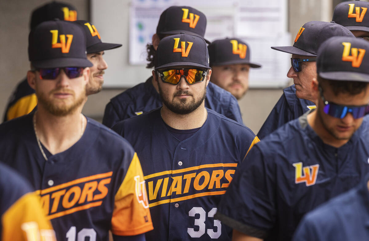 Aviators catcher Shea Langeliers (33) stands in the dugout with teammates during a minor league ...