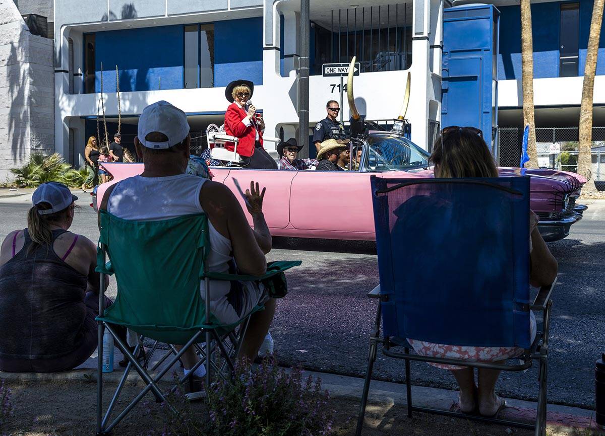 Mayor Caroline Goodman and her husband Oscar greet attendees as they ride in the Las Vegas Day ...