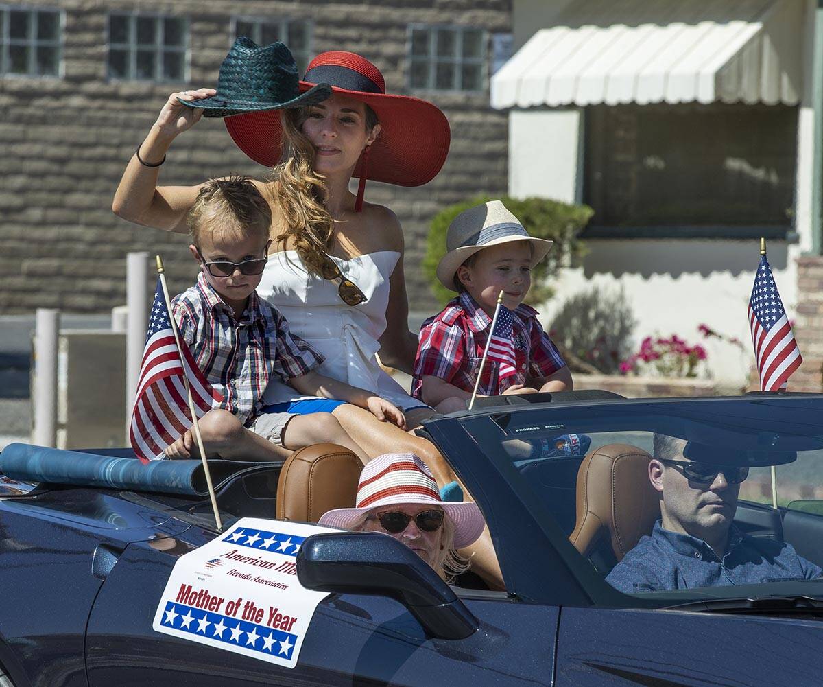 Dianna Klein, The American Mothers of Nevada awarded Mother of the Year, shields the sun from h ...