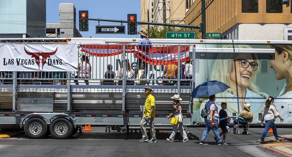 Attendees make their way during the Las Vegas Day Parade as it moves northbound along Fourth St ...