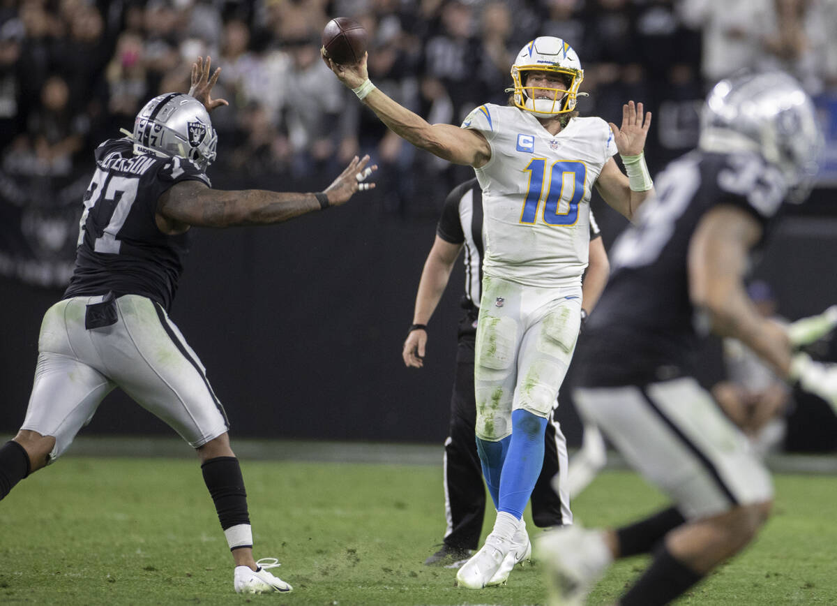 Los Angeles Chargers quarterback Justin Herbert (10) passes over Raiders defensive tackle Quint ...