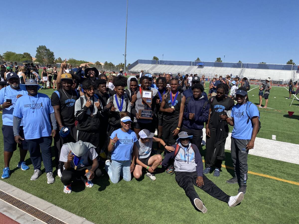 The Canyon Springs boys track and field team celebrates with the trophy after winning the Class ...