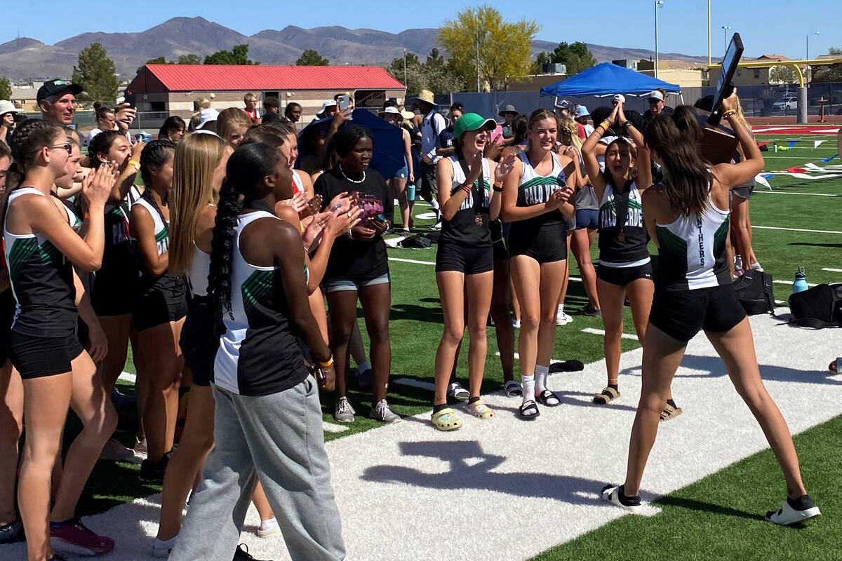 Palo Verde's Alexandra Zuppas walks the trophy back to her teammates after the Panthers won the ...