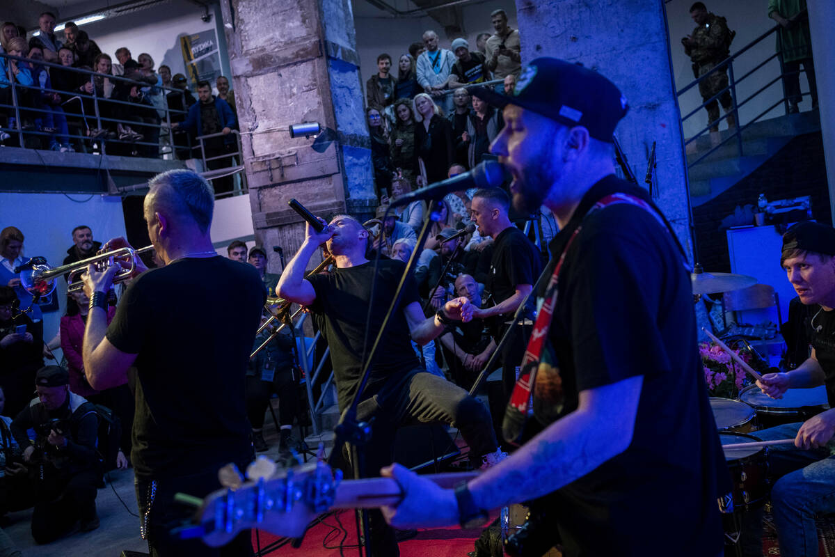 Ukrainian poet and musician Serhiy Zhadan, center, sings during "The music of the resistan ...