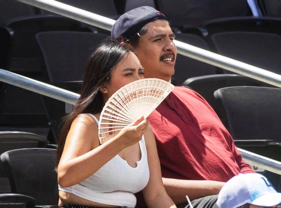 Fans try and stay cool during a minor league baseball game between the Aviators and the Salt La ...