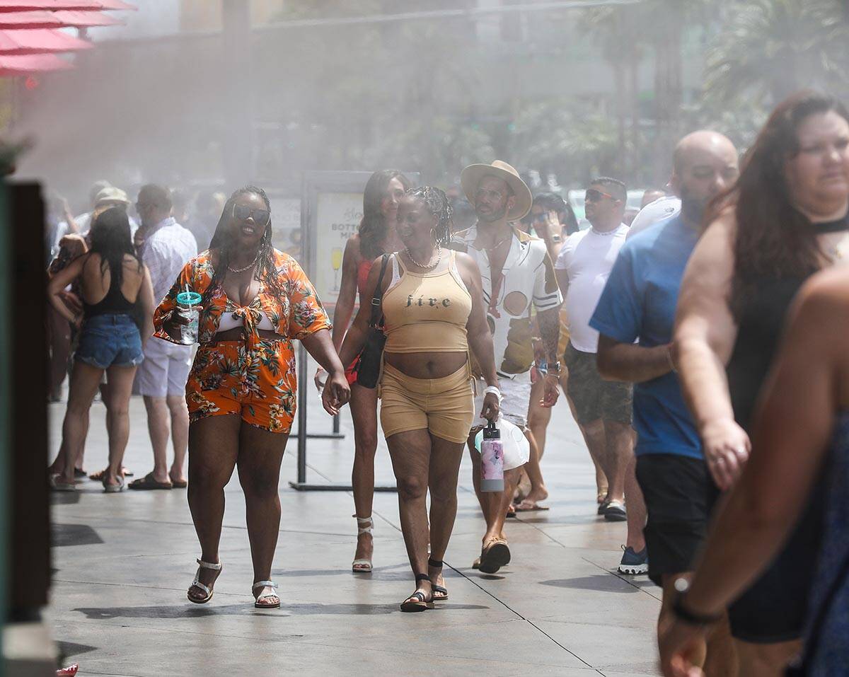 Pedestrians walk through misters on the Strip in Las Vegas, Sunday, May 15, 2022. (Rachel Aston ...