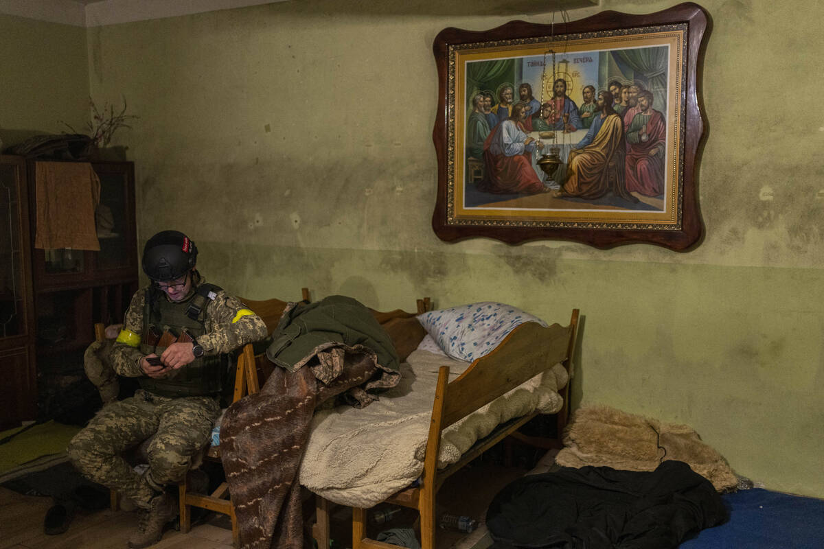 A Ukrainian National Guard soldier takes a break in a house used as temporary base in a recentl ...