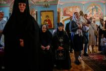 Christian Orthodox worshippers and nuns attend a service at Archangel Saint Michael monastery, ...