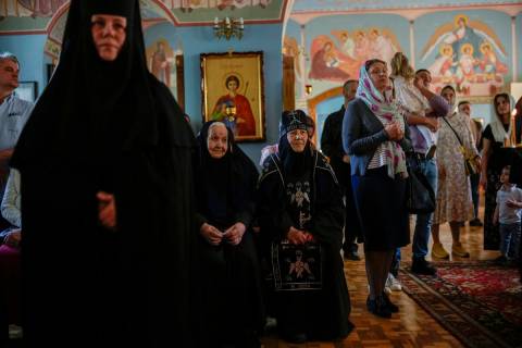 Christian Orthodox worshippers and nuns attend a service at Archangel Saint Michael monastery, ...