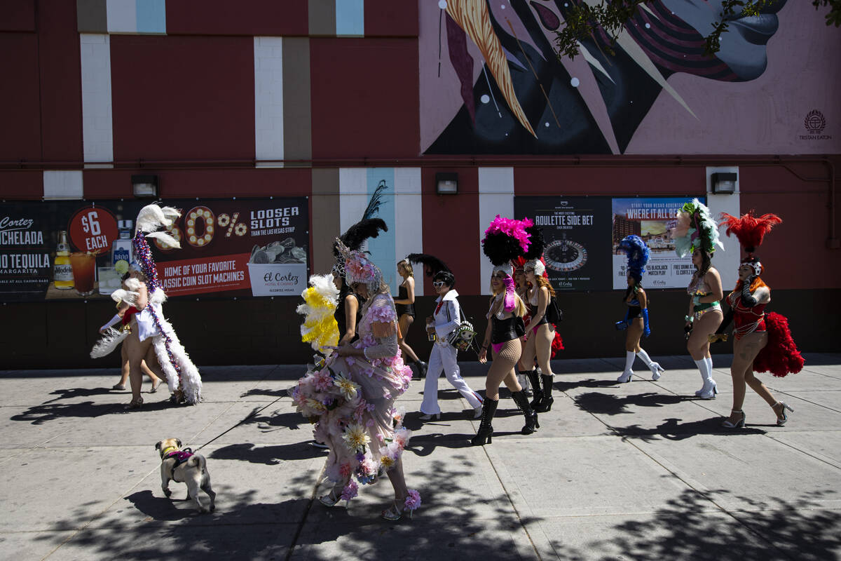 Participants in the Las Vegas Showgirl parade walk along Fremont Street on Sunday, May 15, 2022 ...