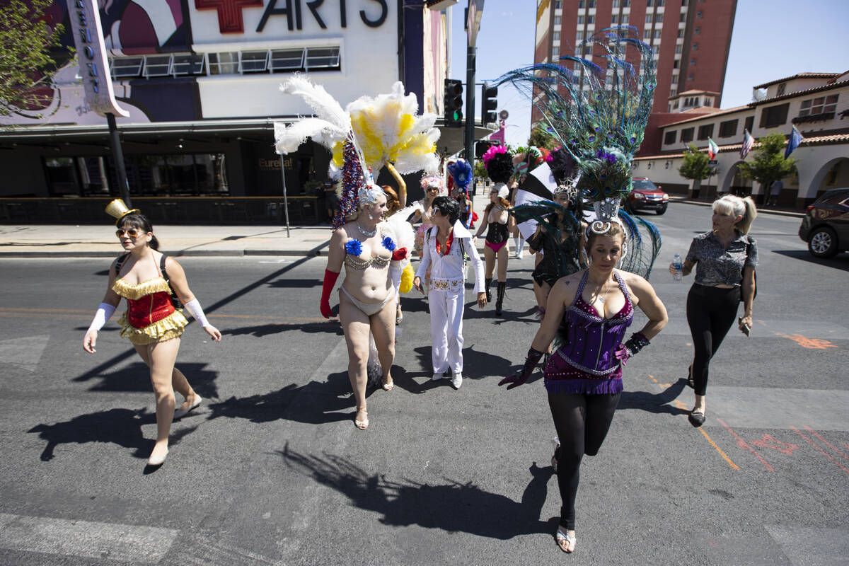 Participants in the Las Vegas Showgirl parade walk cross Fremont Street on Sunday, May 15, 2022 ...