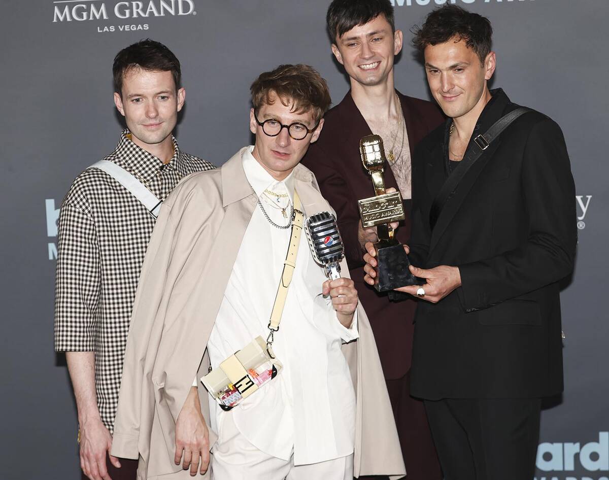Members of Glass Animals pose with the "Top Rock Artist” award in the backstage press room du ...
