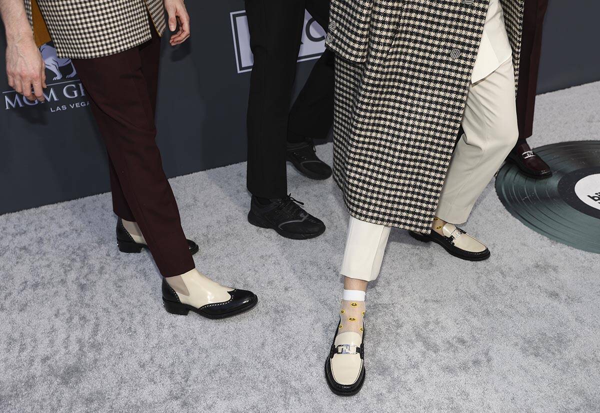 Members of Glass Animals show off their shoes on the red carpet for the Billboard Music Awards ...