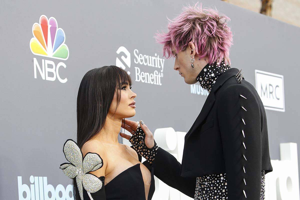 Megan Fox and Machine Gun Kelly pause on the red carpet for the Billboard Music Awards at the M ...