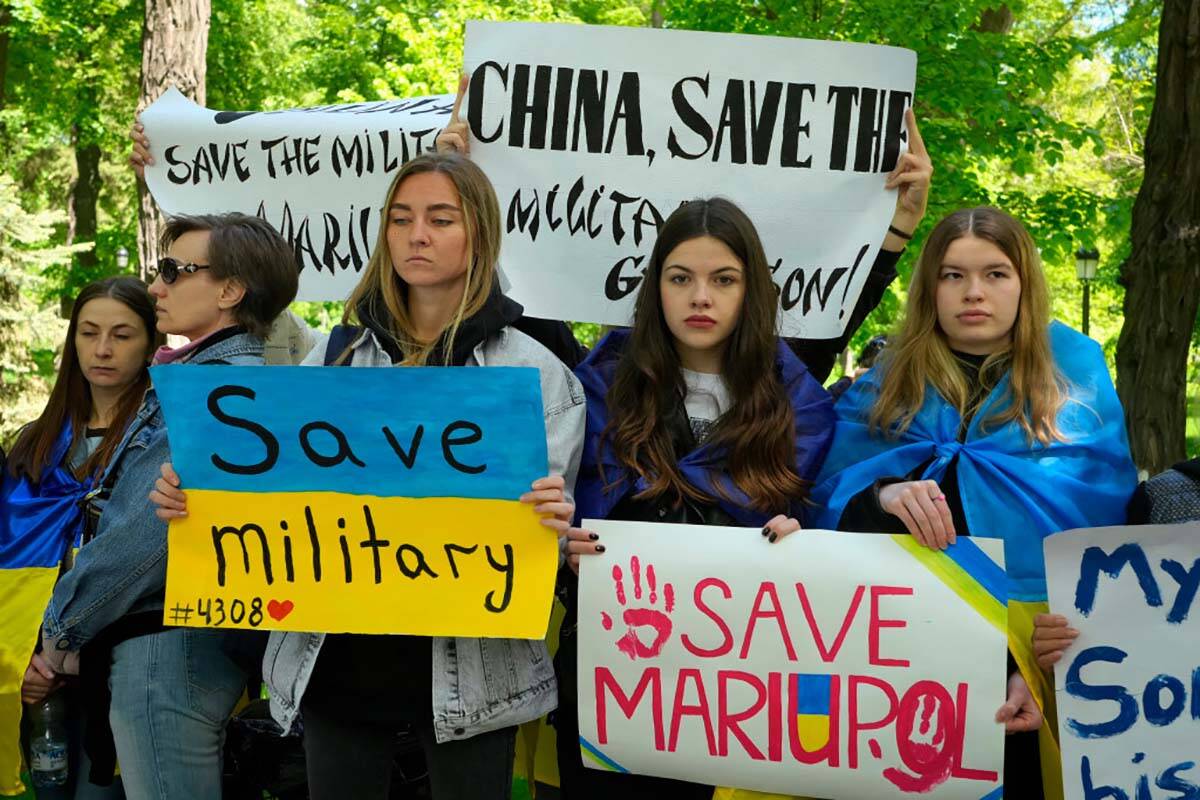 Ukrainian women picket in front of the Chinese embassy in Kyiv, Ukraine, Tuesday, May 17, 2022. ...