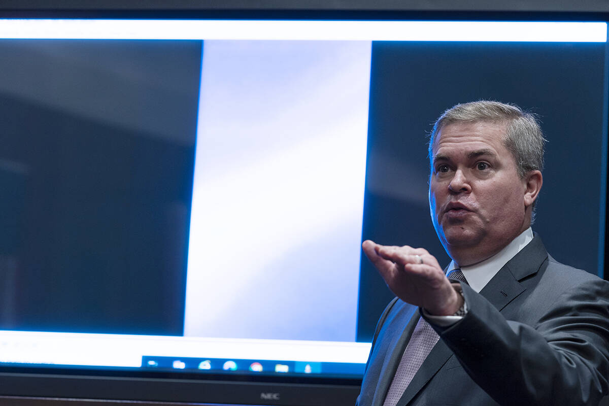 Deputy Director of Naval Intelligence Scott Bray speaks in front of a video display of a UAP du ...