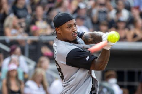 Las Vegas Raiders Josh Jacobs (28) connects on a hit during a charity softball game versus the ...