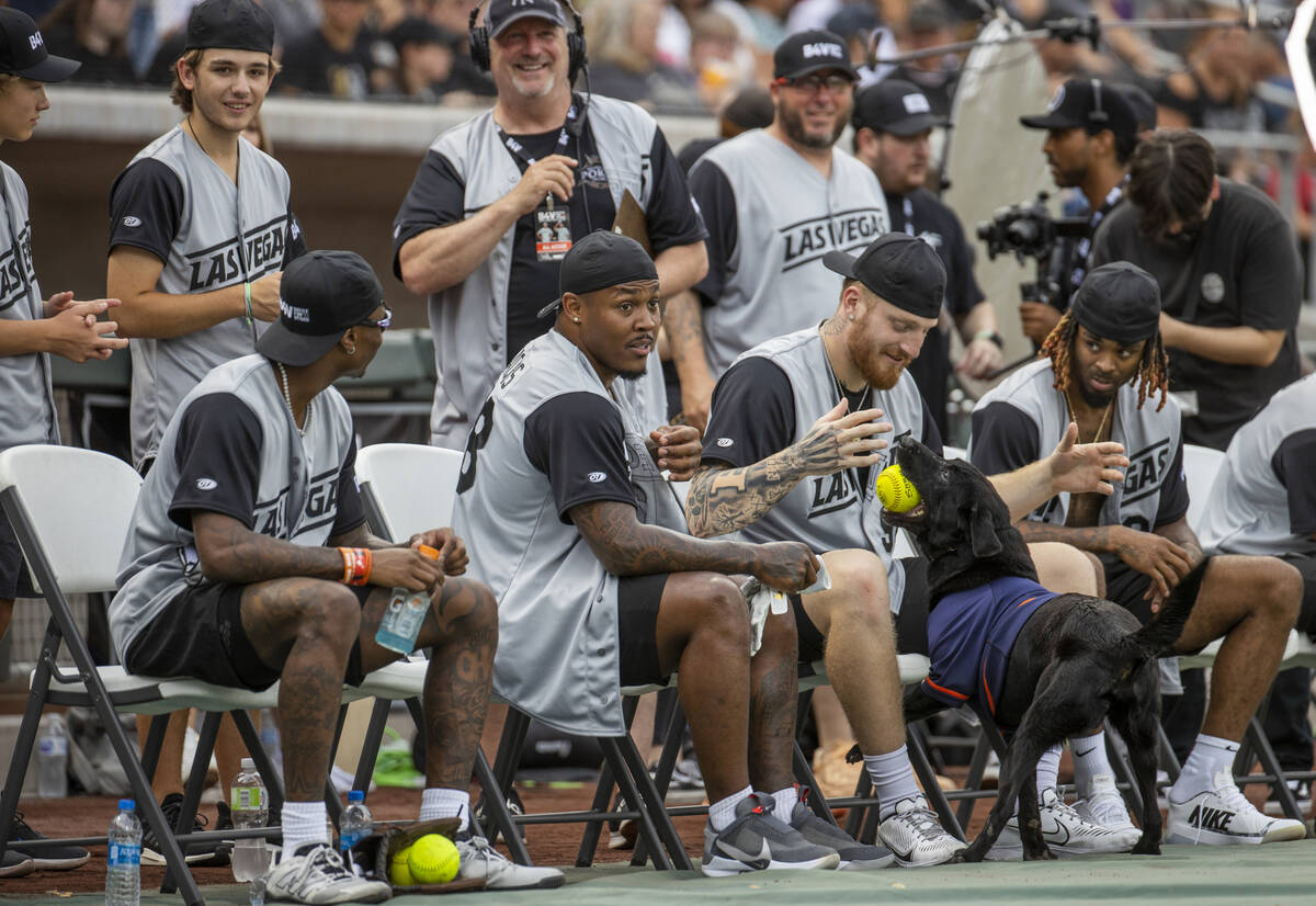 Las Vegas Raiders Josh Jacobs (28, center) looks on as teammate Maxx Crosby (98) and Damon Arne ...