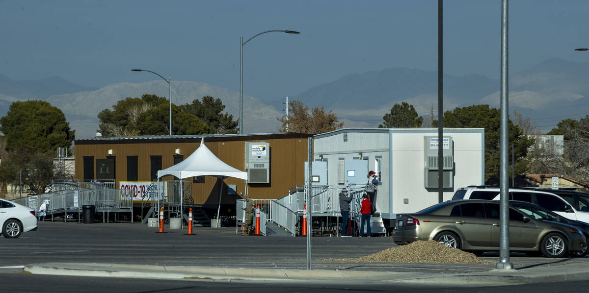 People wait and are served for COVID-19 testing at the CSN West Charleston campus on Tuesday, J ...