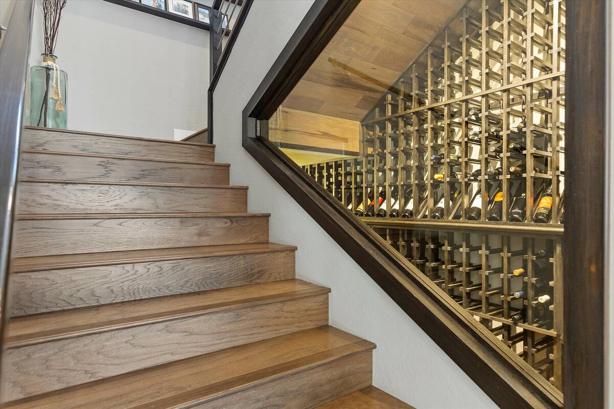 A wine cellar is nuzzled underneath a stairway inside professional poker player Chance Kornuth' ...