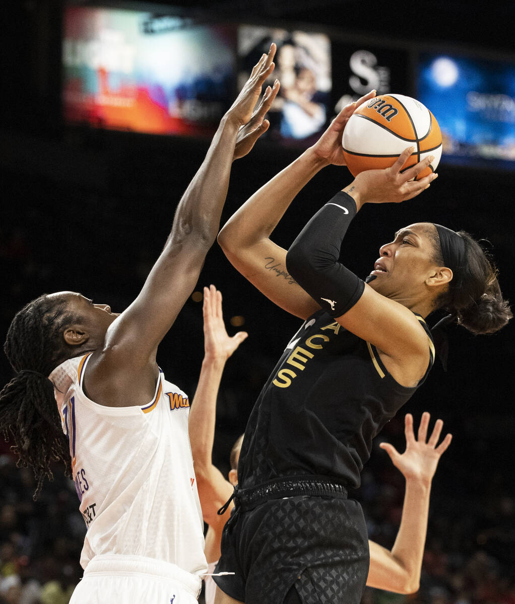 Aces forward A'ja Wilson (22) shoot over Phoenix Mercury center Tina Charles (31) in the first ...