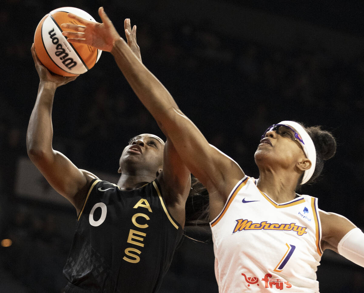 Aces guard Jackie Young (0) drives past Phoenix Mercury guard Diamond DeShields (1) in the firs ...