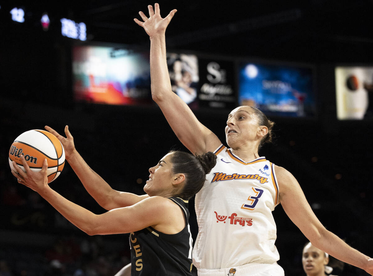 Aces guard Kelsey Plum (10) slices to the rim past Phoenix Mercury guard Diana Taurasi (3) in t ...