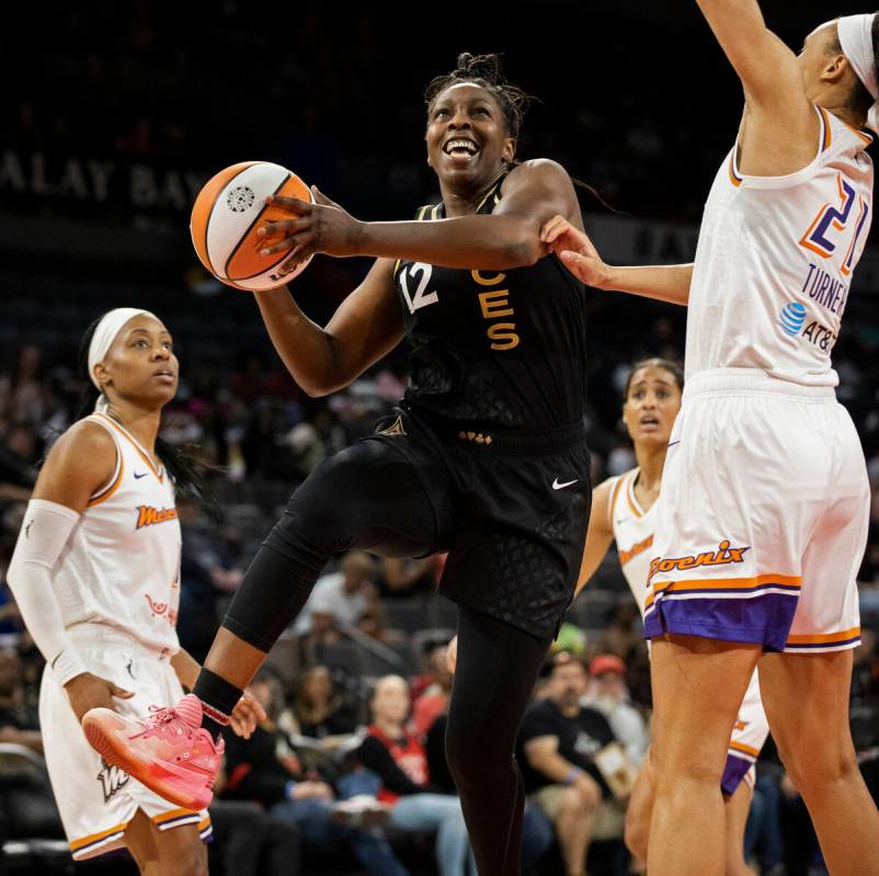 Aces guard Chelsea Gray (12) drives past Phoenix Mercury forward Brianna Turner (21) in the sec ...