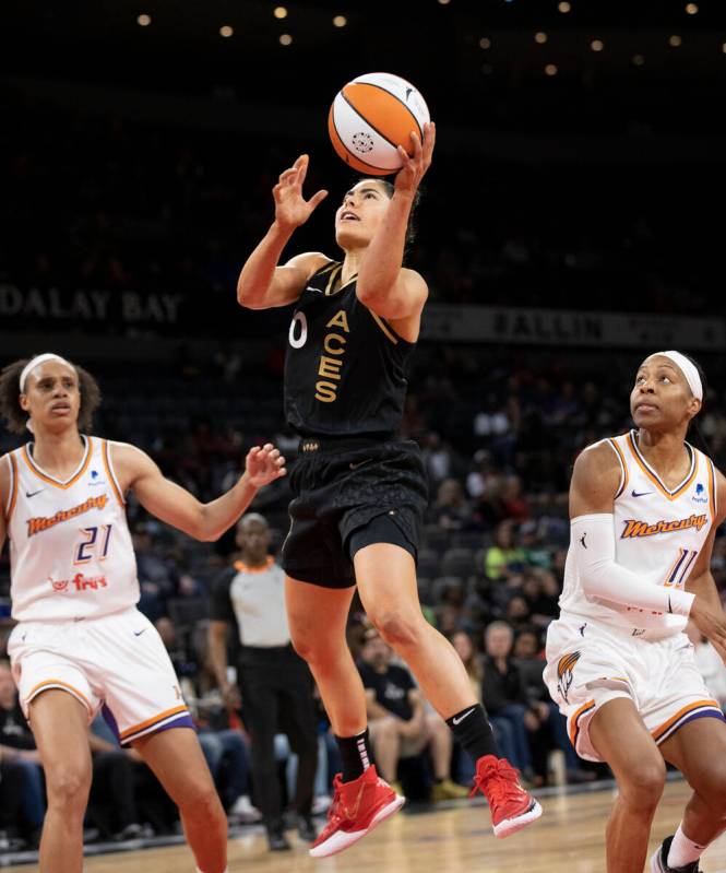 Aces guard Kelsey Plum (10) drives past Phoenix Mercury forward Brianna Turner (21) and Phoenix ...