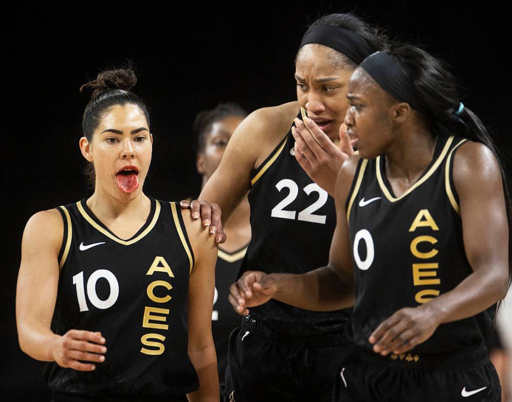 Aces forward A'ja Wilson (22) and Aces guard Jackie Young (0) show concern for teammate Kelsey ...