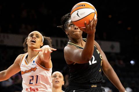 Aces guard Chelsea Gray (12) drives past Phoenix Mercury forward Brianna Turner (21) in the fir ...