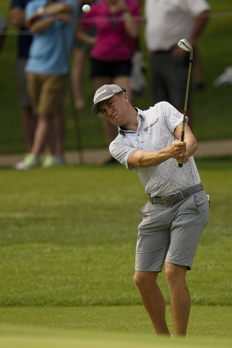 Justin Thomas chips to the green on the seventh hole during a practice round for the PGA Champi ...