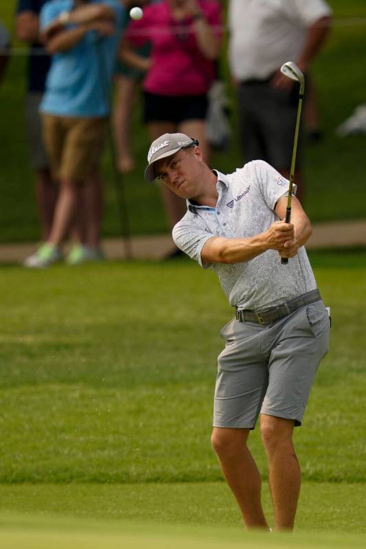 Justin Thomas chips to the green on the seventh hole during a practice round for the PGA Champi ...