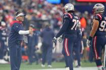 New England Patriots offensive coordinator Josh McDaniels congratulates tackle Isaiah Wynn (76) ...