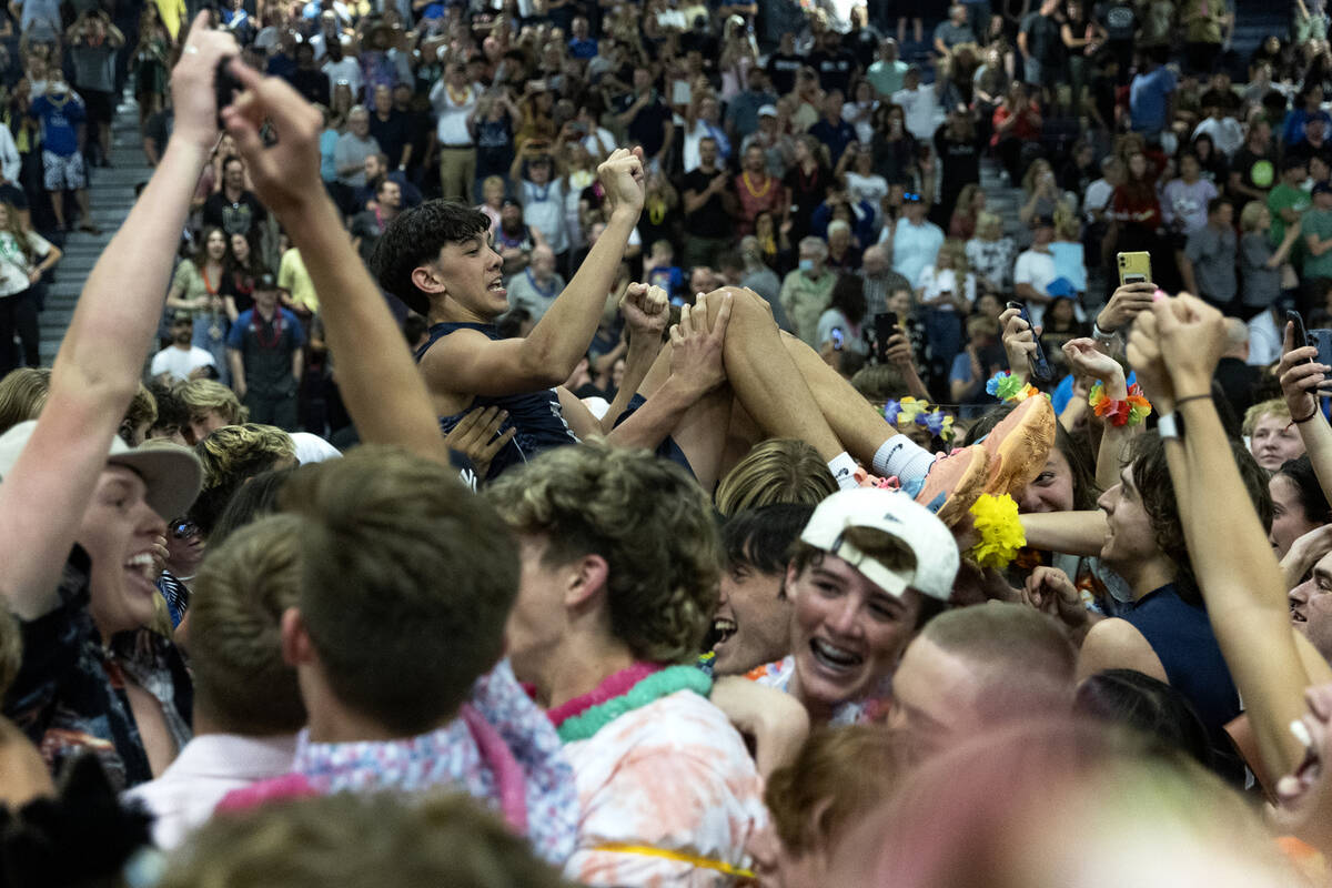 Shadow Ridge’s Caleb Fisher (3) is lifted by fans after his team won the Class 5A boys v ...