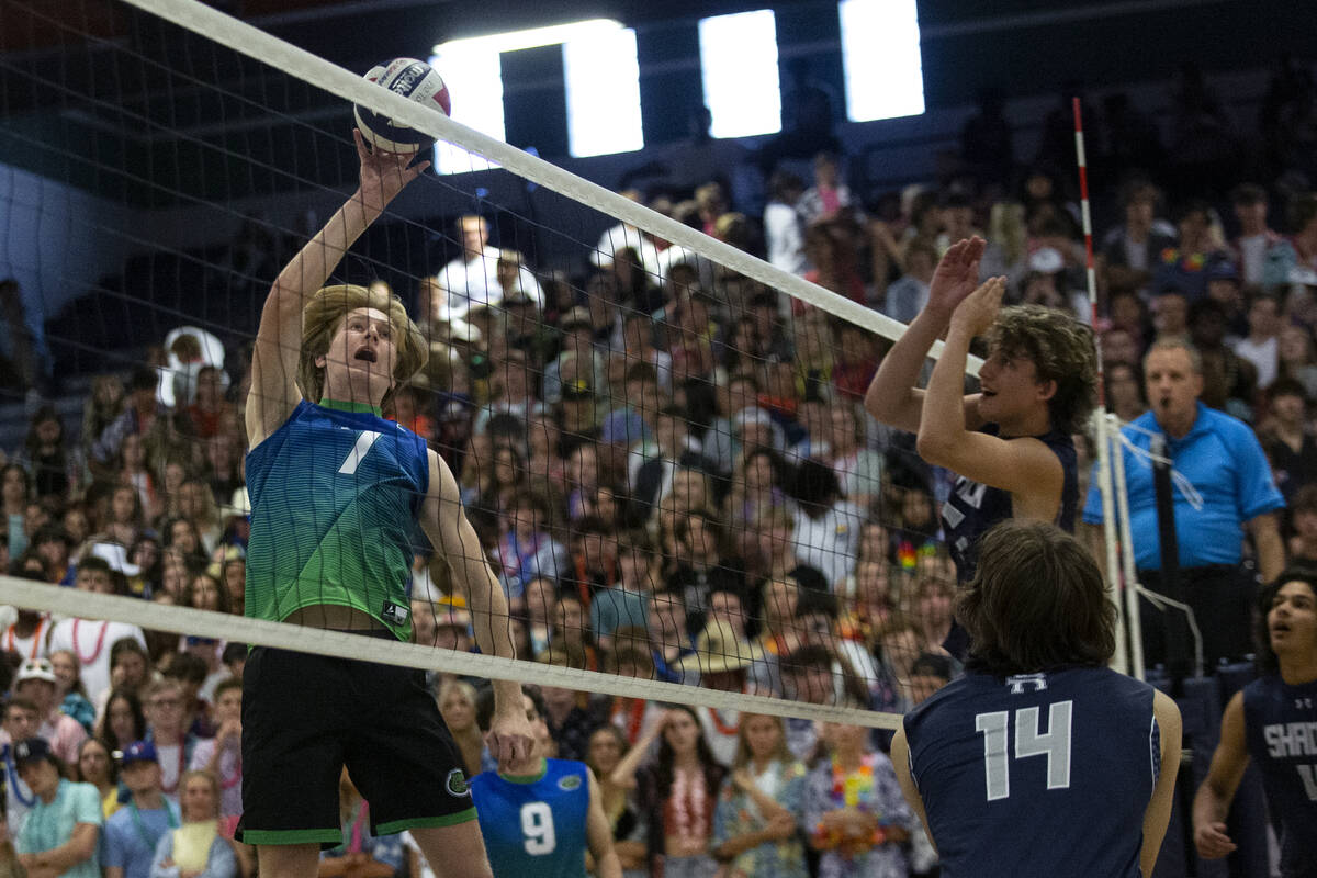 Green Valley’s Ben Hanson spikes while Shadow Ridge’s Brady Beko (14) and Tyler K ...