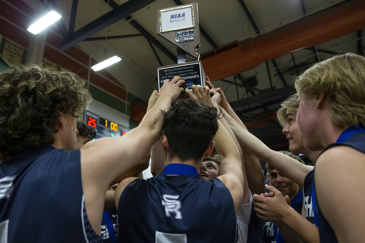 Shadow Ridge holds up their trophy after winning the Class 5A boys volleyball state championshi ...