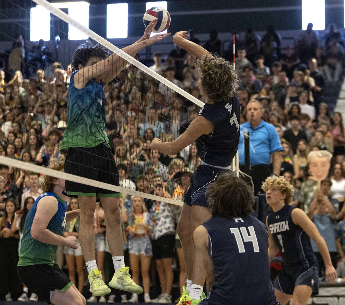 Shadow Ridge’s Tyler Kirk (7) spikes while Green Valley’s Dominic Andrulis (1) bl ...