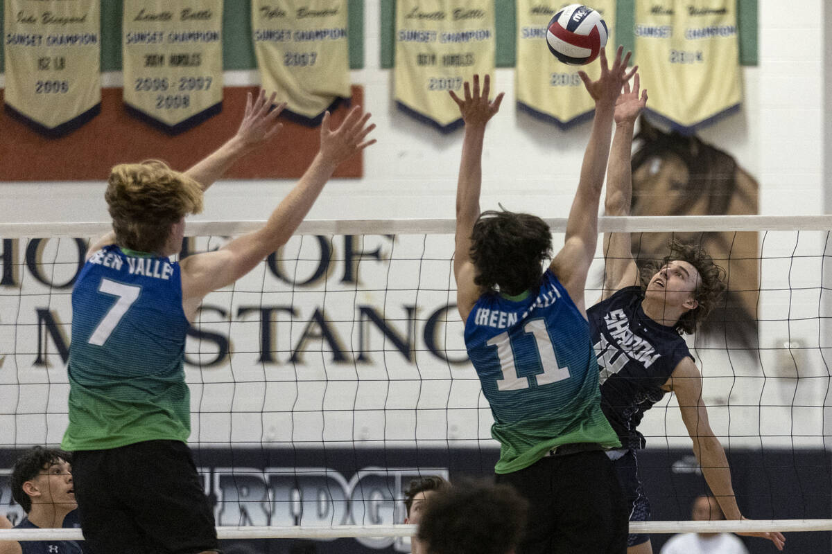 Green Valley’s Ben Hanson (7) and Aiden Olsen (11) jump to block while Shadow Ridge  ...