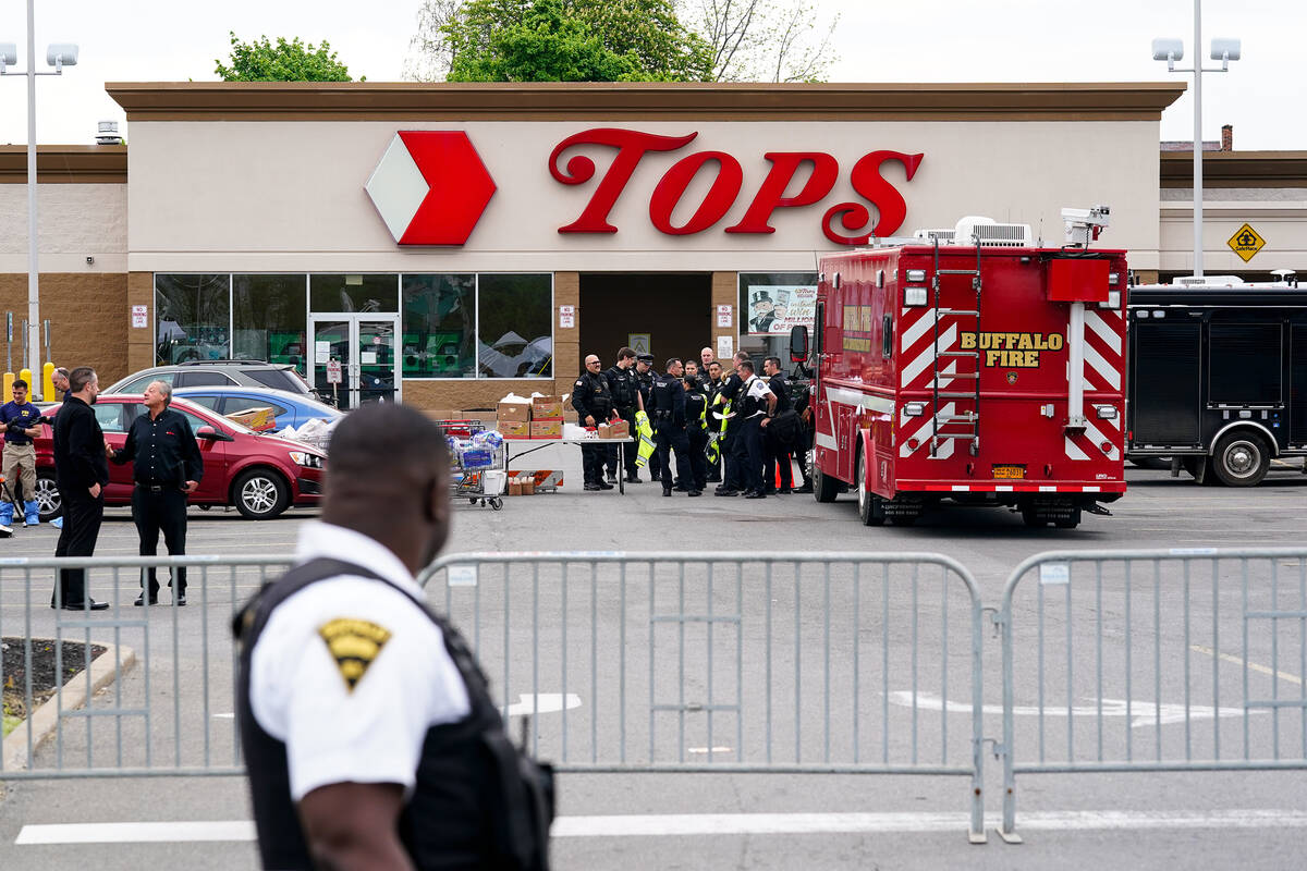 Investigators work the scene of a shooting at a supermarket, in Buffalo, N.Y., Monday, May 16, ...