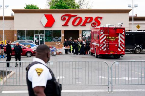 Investigators work the scene of a shooting at a supermarket, in Buffalo, N.Y., Monday, May 16, ...