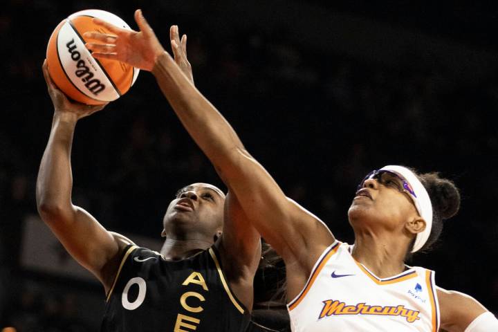 Aces guard Jackie Young (0) drives past Phoenix Mercury guard Diamond DeShields (1) in the firs ...