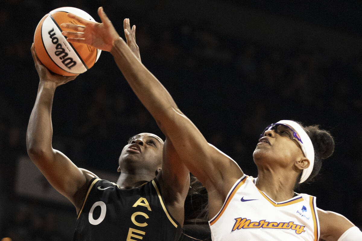 Aces guard Jackie Young (0) drives past Phoenix Mercury guard Diamond DeShields (1) in the firs ...