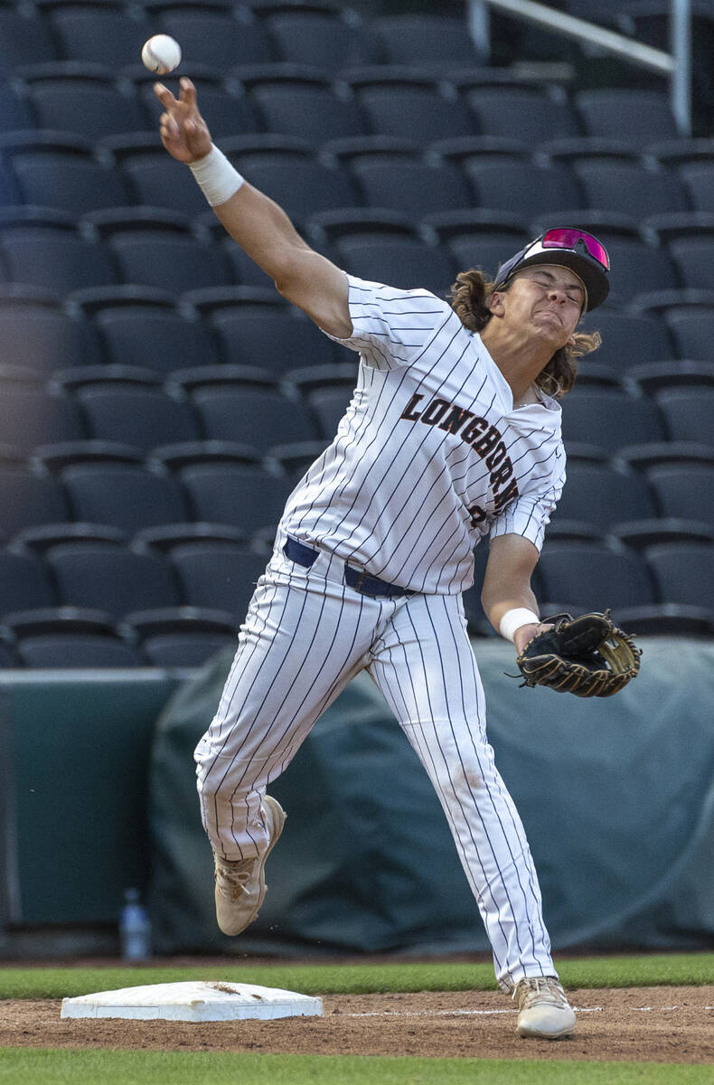 Legacy third baseman Theodore Chartier (8) throws to first base as a Shadow Ridge runner sprint ...