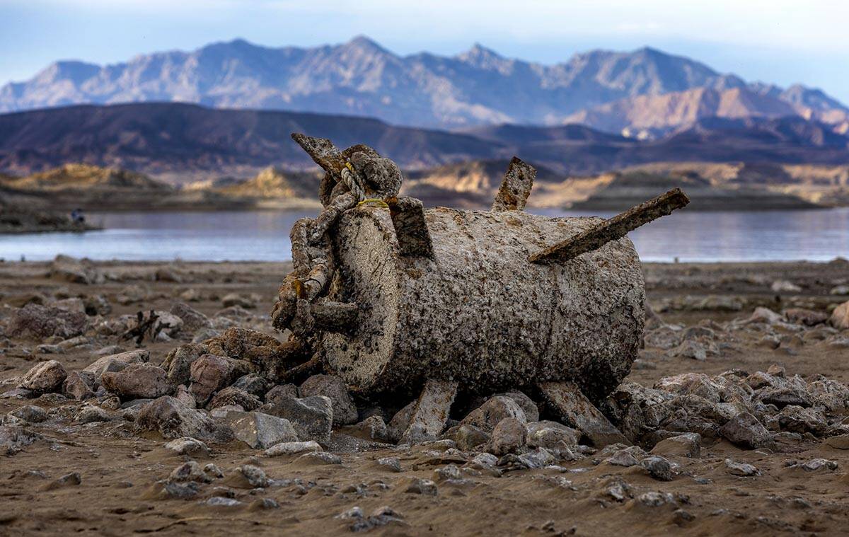 An old barrel with chains is left behind as the waterline continues to recede about the closed ...