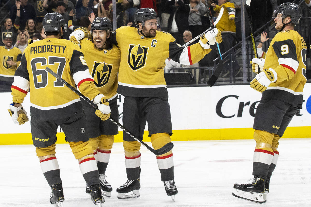 Golden Knights center Chandler Stephenson (20) celebrates with Golden Knights right wing Mark S ...