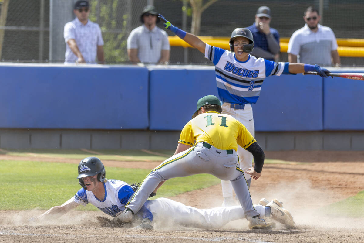 Basic runner Colin Hushaw (15) arrives safe at home plate over Bishop Manogue catcher Donoven D ...
