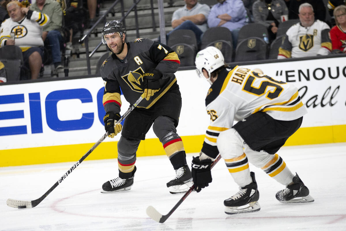 Golden Knights defenseman Alex Pietrangelo (7) looks to pass while Bruins left wing Erik Haula ...