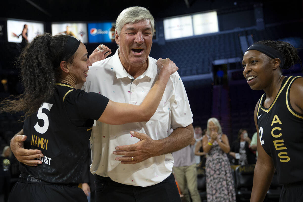 Former Las Vegas Aces head coach Bill Laimbeer embraces forward Dearica Hamby (5) while guard C ...