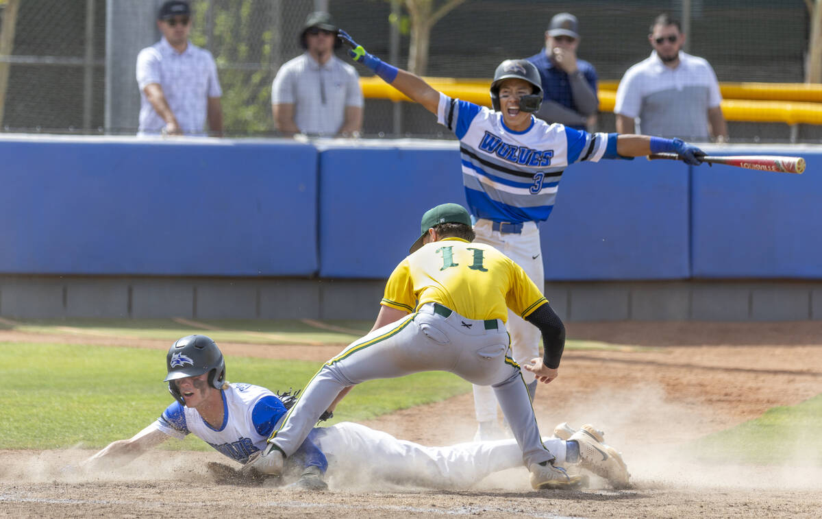 Basic runner Colin Hushaw (15) arrives safe at home plate over Bishop Manogue catcher Donoven D ...